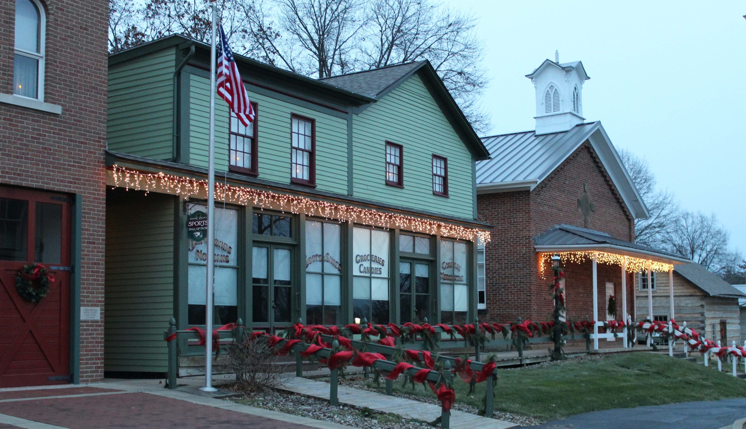 General store and schoolhouse decorated for the holidays